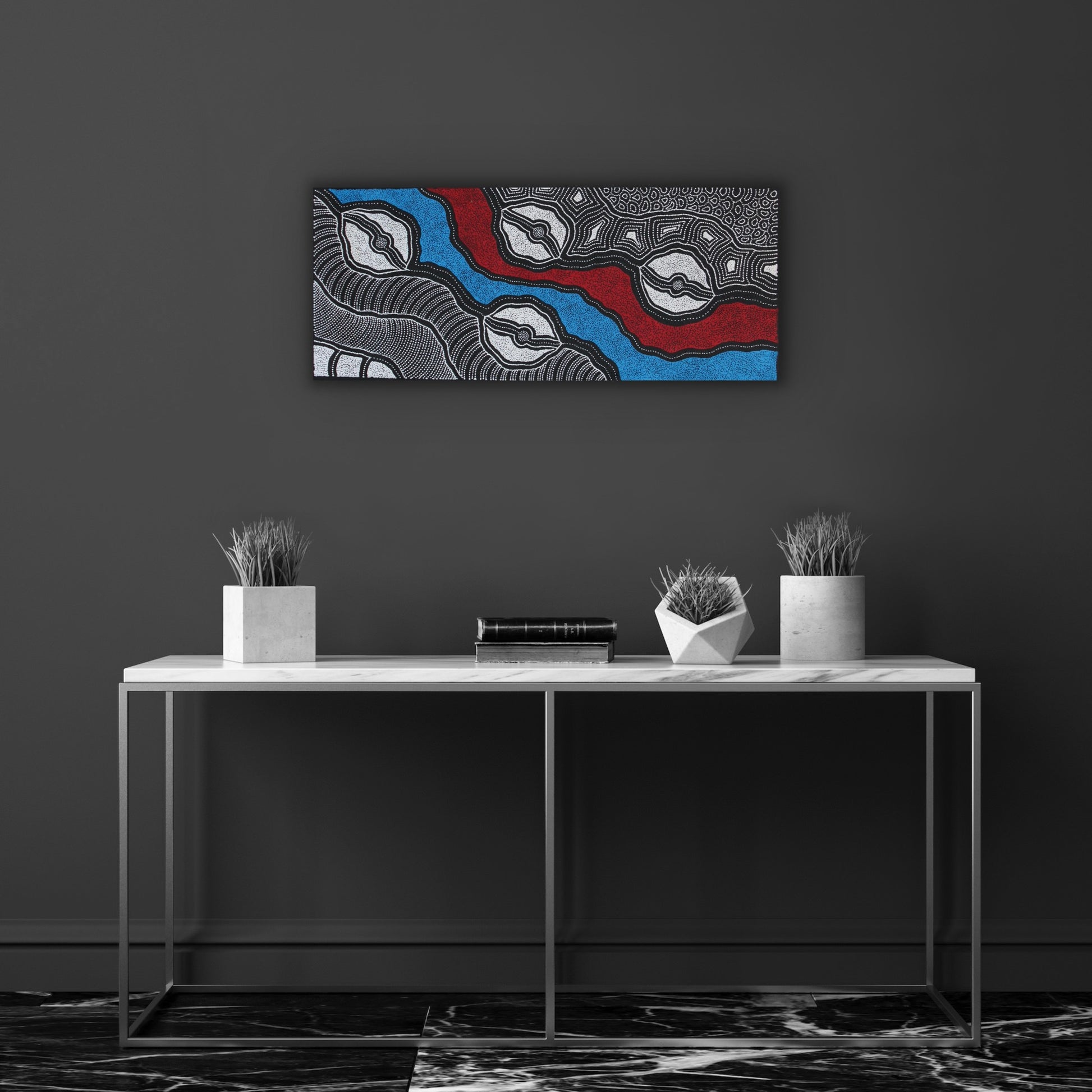 A painting by Delvine Pitjara, featuring intricate white dots and fine linework on a canvas with red and blue elements, representing aspects of Australian Aboriginal art.