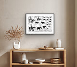 Framed black and white linocut print by Jill Daniels on a wall above a wooden console table with decorative items.