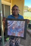 Tanya Bird Mpetyane holding her painting.