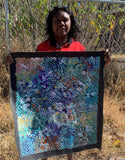 Belinda Golder Kngwarreye holding her Bush Plum Dreaming painting Multicoloured 68x63cm