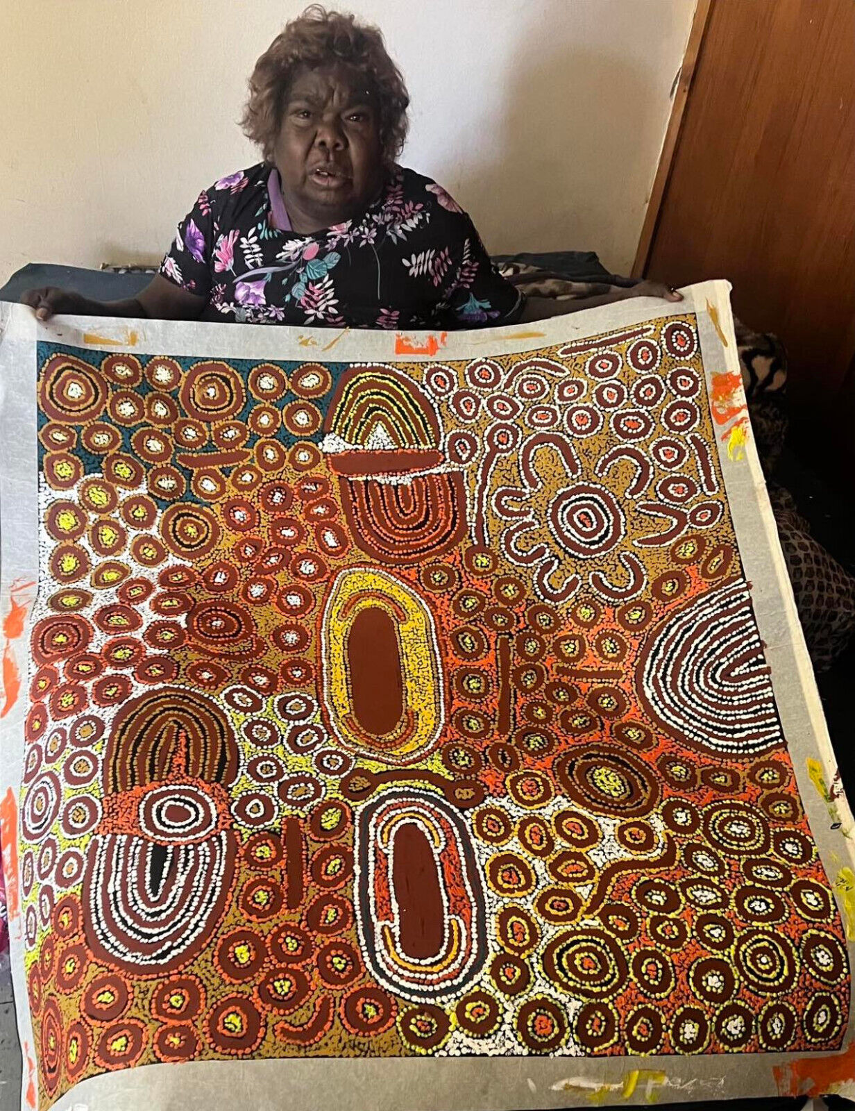 Marlene Young Nungarrayi holding her 'My Country' painting, 105x95cm