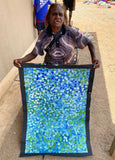 Bessie Pitjara holding her 'Anwekety (Bush Plum)' painting, 90x60cm