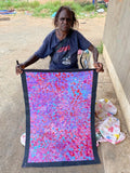 Bessie Pitjara holding her 'Anwekety (Bush Plum)' painting, 90x60cm