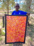 Bessie Pitjara holding her 'Anwekety (Bush Plum)' painting, 90x60cm