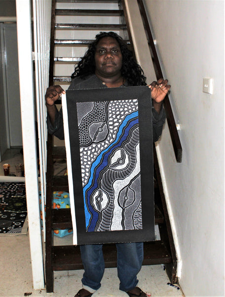 Delvine Pitjara holding her 'My Country' painting 71x30cm White Blues