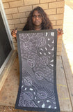 Delvine Pitjara holding her 'My Country' painting 101x44cm White Black