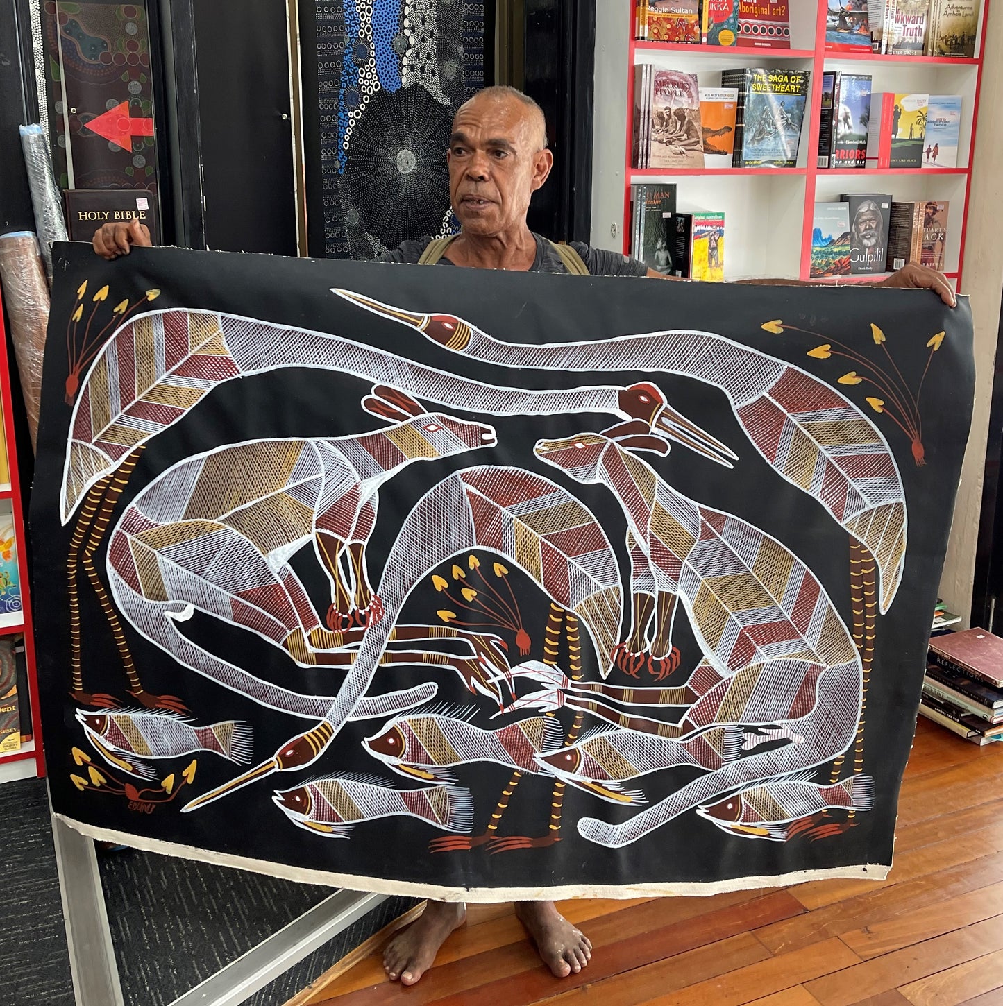 Eddie Blitner holding his 'Billabong Scene' painting 95x147cm