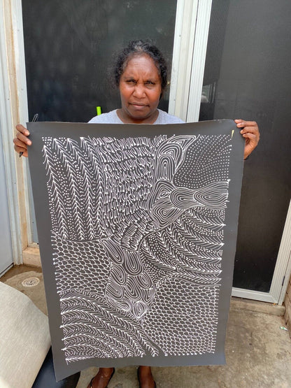 Freda Price Pitjara holding her 'My Country' painting 90x60cm