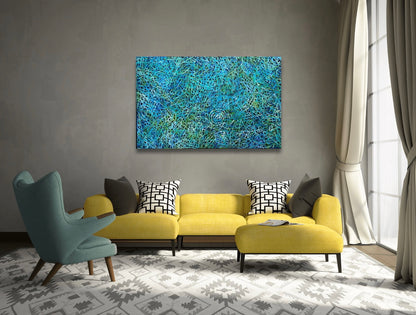 An awelye painting by Betty Club Mbitjana in blue, green, aqua and white colours in a modern living room setting.