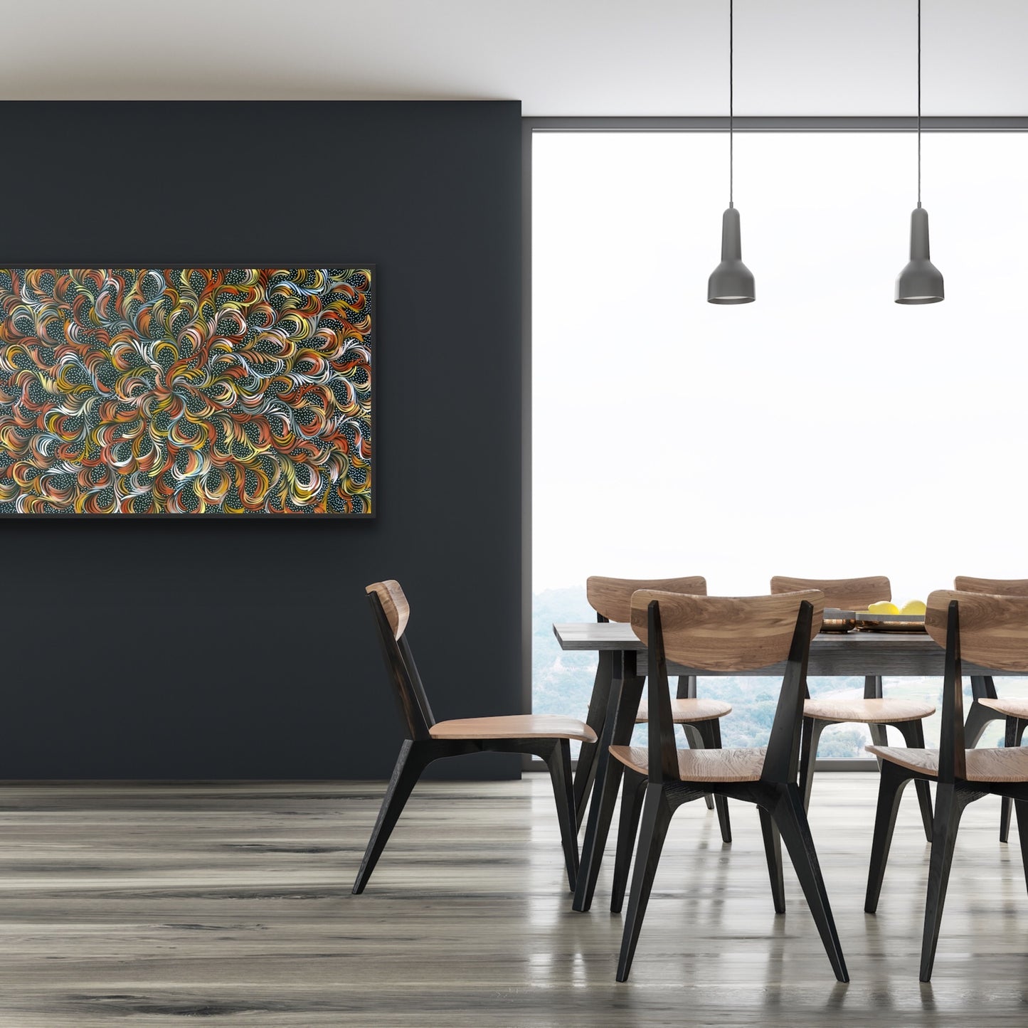 A painting by Selina Numina Kamprina hanging on a black wall beside a dining table and wooden chairs.
