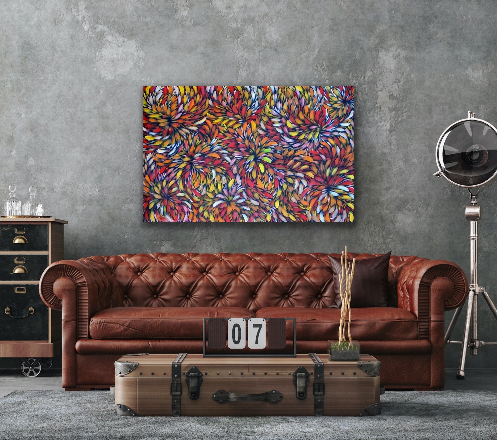 A painting by Selina Numina Kamprina hanging above a brown couch. table and other décor items.