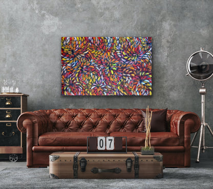 A painting by Selina Numina Kamprina hanging above a brown couch. table and other décor items.
