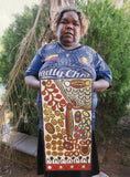 Daphne Larry Nampitjinpa holding her 'My Country' painting 30x60cm