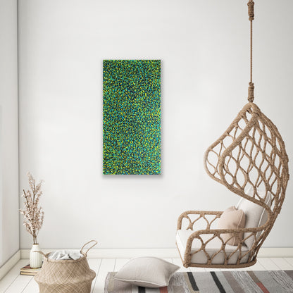 A painting by Gloria Petyarre featuring bush medicine leaves in green, aqua and yellow on a white wall.