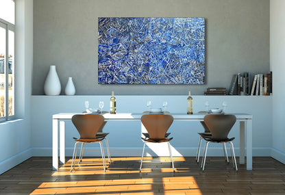 A 155x95cm painting by Betty Club Mbitjana in blue, light blue, grey, and white hanging above a dining table.