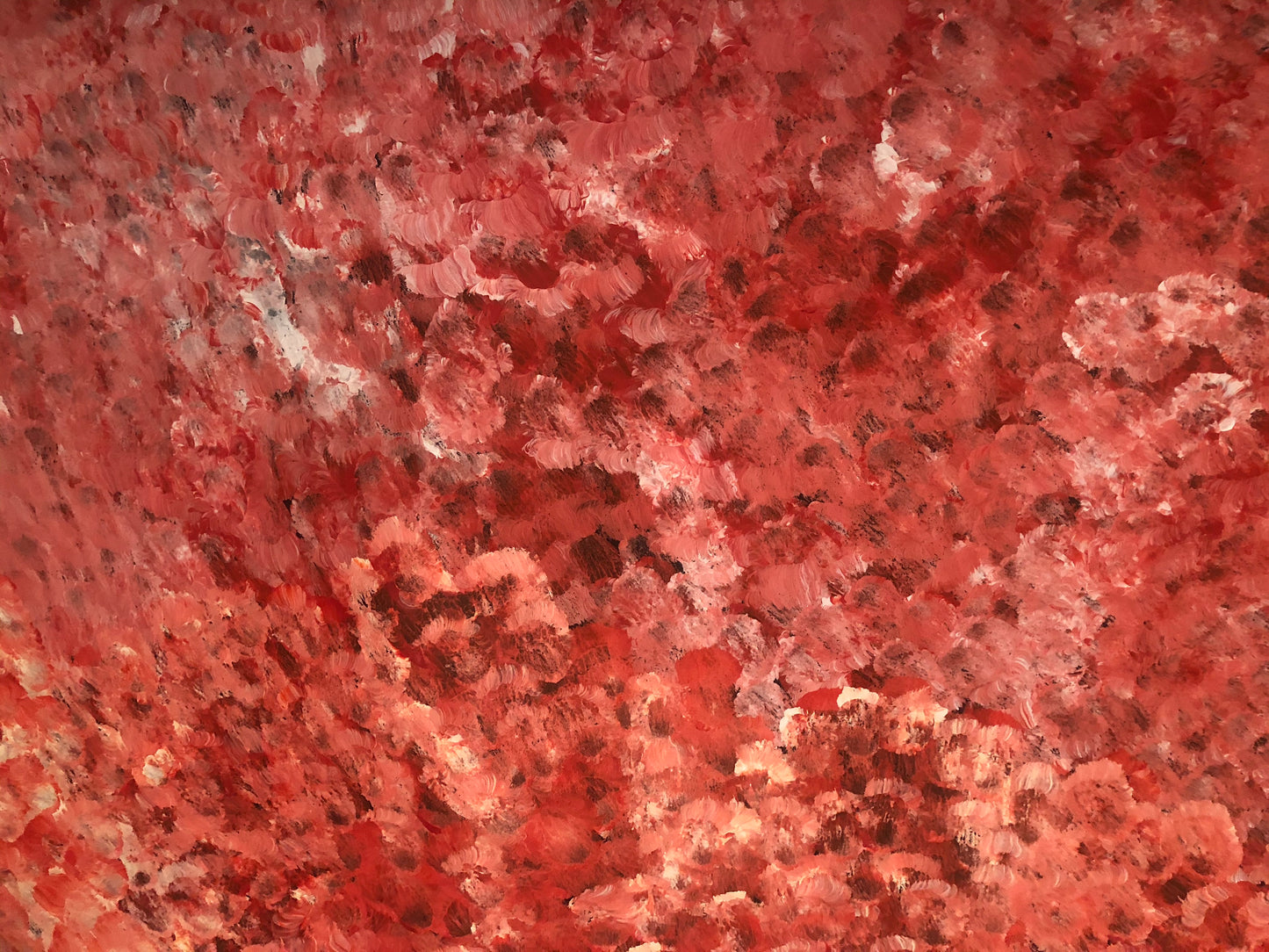 an extreme close-up of a 150x200cm painting featuring an abstract pattern of orange tones, representing the 'Bush Plum Dreaming' artwork by Polly Ngale.