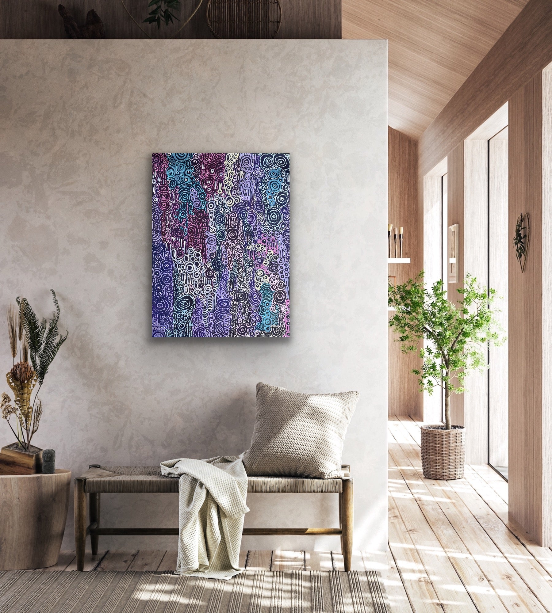 A painting by Meredith Curley featuring a pattern of swirling circles in various shades of blue, purple, pink and white on a black background in a modern retail waiting area. 
