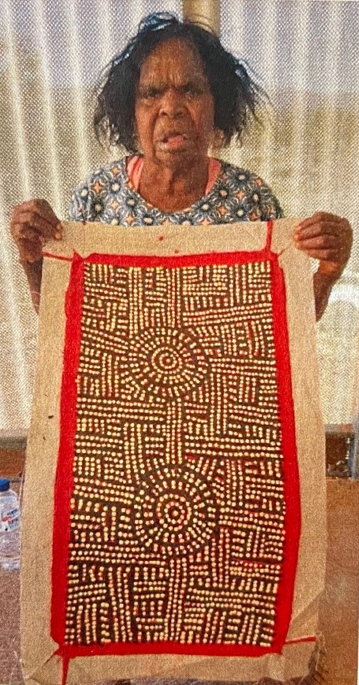 Bambatu Napangardi holding her 'Kungka Tjukurrpa' painting, 30x60cm