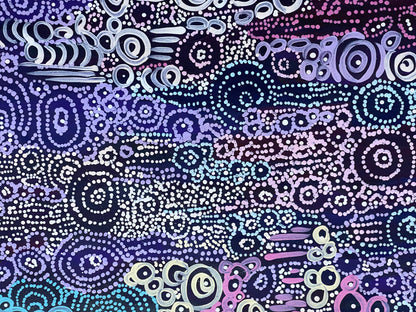 A close-up of Meredith Curley's artwork featuring a pattern of swirling circles in various shades of blue, purple, and white on a black background.