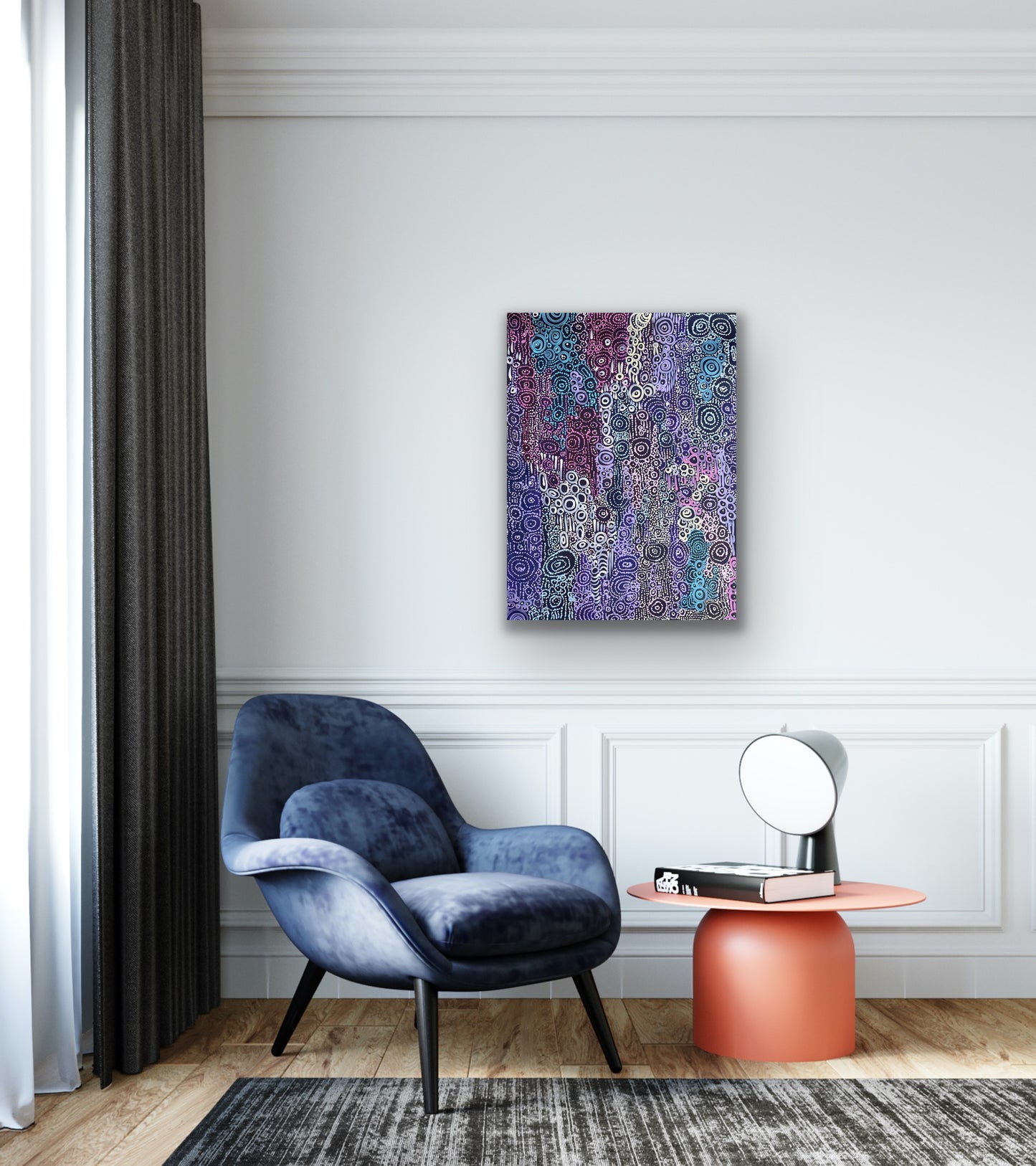 A painting by Meredith Curley featuring a pattern of swirling circles in various shades of blue, purple, pink and white on a black background in a modern sitting area. 