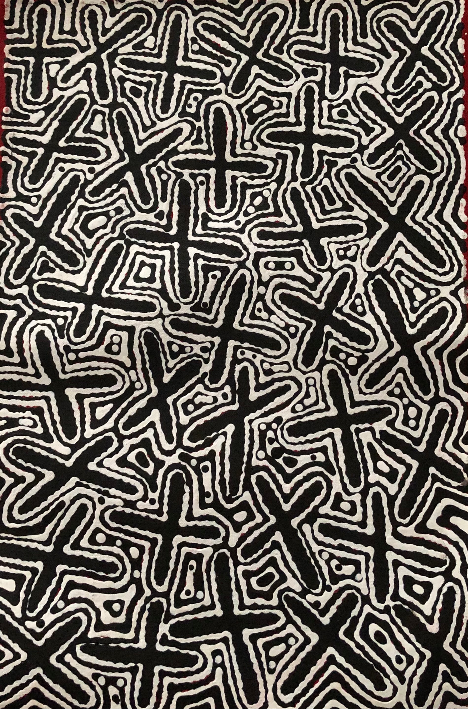 A canvas painting featuring abstract black and white patterns representing the 'Budgerigar Dreaming' with Concentric circles and cross-like shapes.