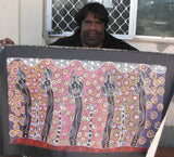 Cindy Wallace Nungarrayi holding her 'Women dancing at Ceremony' painting 50x90cm