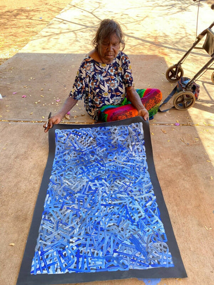 Betty Club Mbitjana holding her My Mother's Dreaming painting 60x90cm 