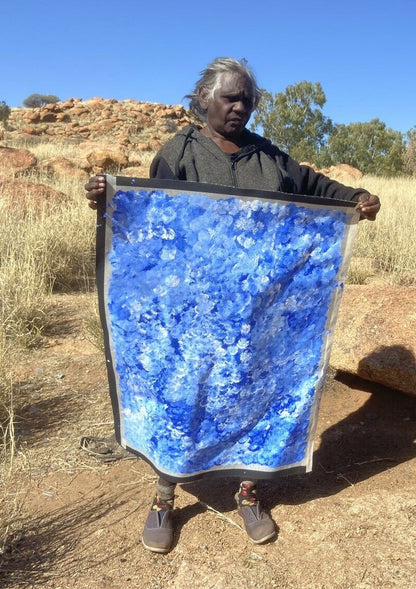 Bessie Pitjara holding her 'Anwekety (Bush Plum)' painting, 90x65cm