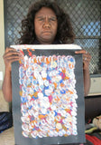 Belinda Golder Kngwarreye holding her Bush Plum Dreaming painting