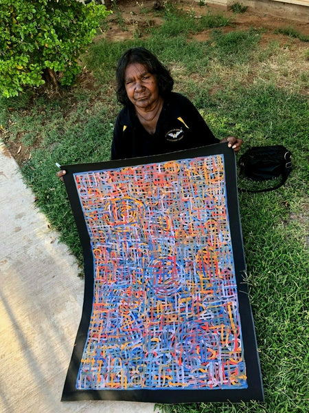 Betty Club Mbitjana holding her My Mother's Dreaming painting 60x90cm 