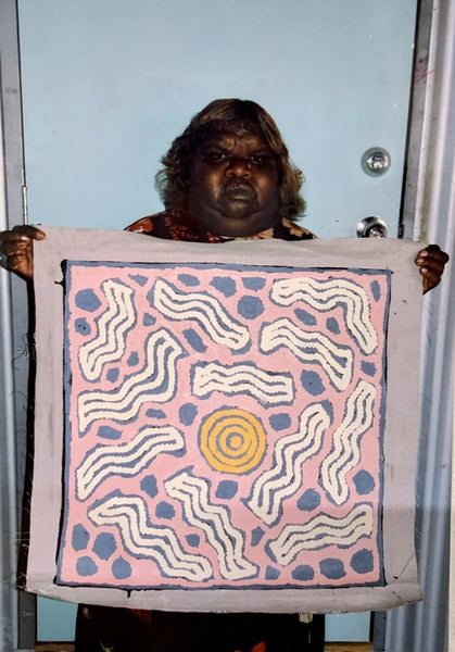 Glenys Gibson Napaltjarri holding her 'My Country' painting 60x60cm