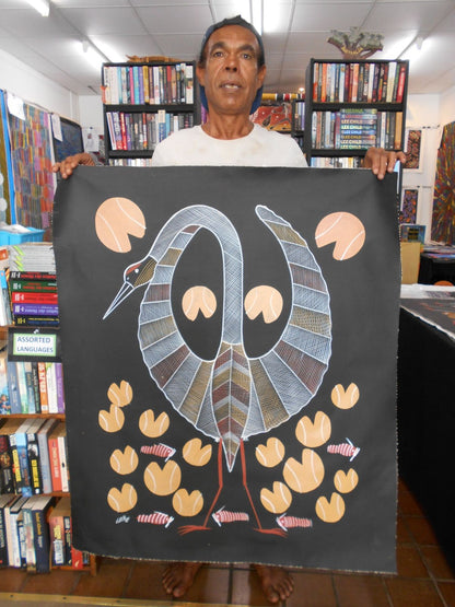 Eddie Blitner holding his 'Brolga Spirit' painting 92x75cm
