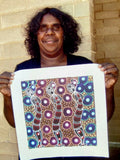 Colleen Wallace Nungarrayi holding her 'Dreamtime Sisters' painting 32x32cm