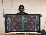 Colleen Wallace Nungarrayi holding her 'Dreamtime Sisters' painting 44x89cm