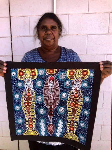 Colleen Wallace Nungarrayi holding her 'Dreamtime Sisters' painting 45x45cm