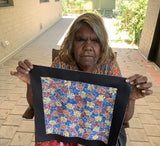 Audrey Morton Kngwarreye holding her Alpitye/Bush Flowers painting 30x30cm