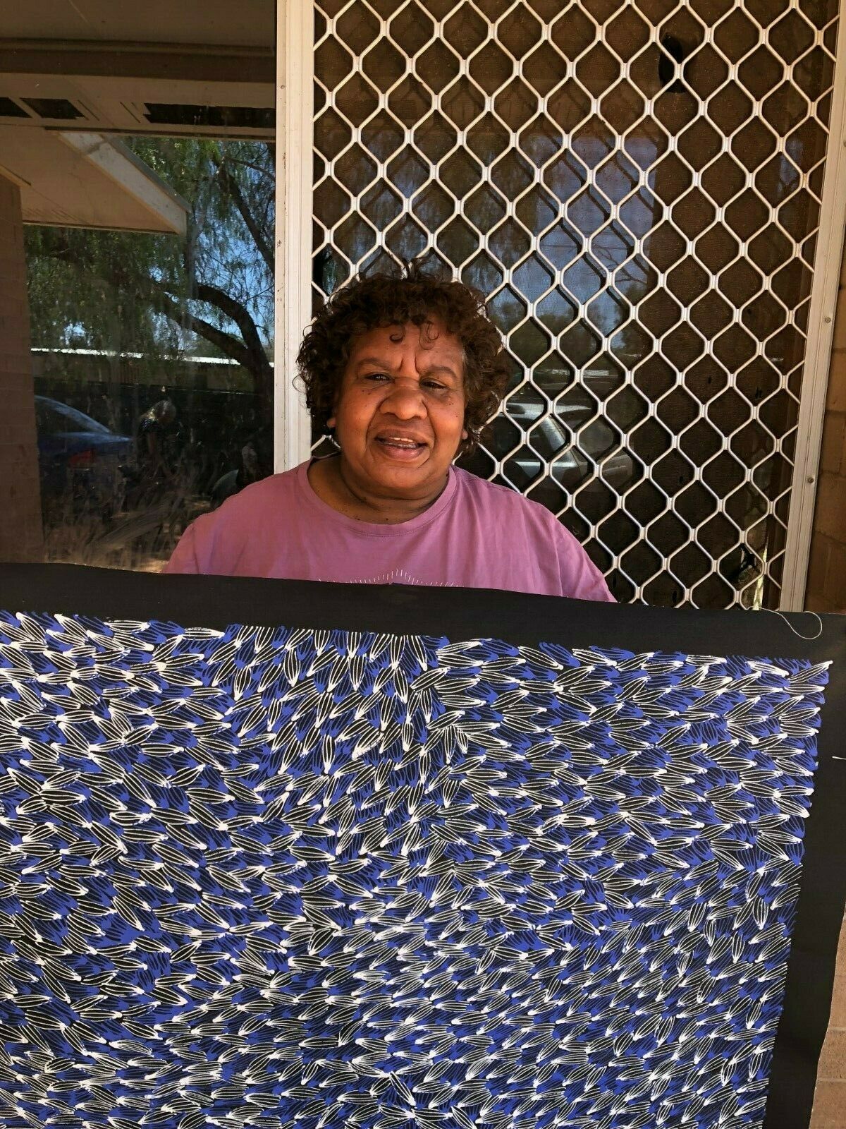 Abie Loy Kemarre holding 'Bush Medicine Leaf' 110h x 100w