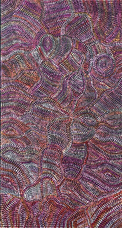 An acrylic painting on primed linen by Joy Purvis Pitjara, featuring a detailed pattern of Bush Yam seeds with a mix of red, pink, and white dots.