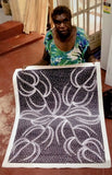 Doreen Dickson Nakamarra holding her 'Ngurlu (Damper Seed Dreaming)' 72x87cm