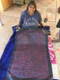 Annie Nelson Napangardi holding her 'Pattern of Two Creeks' painting, 68x110cm